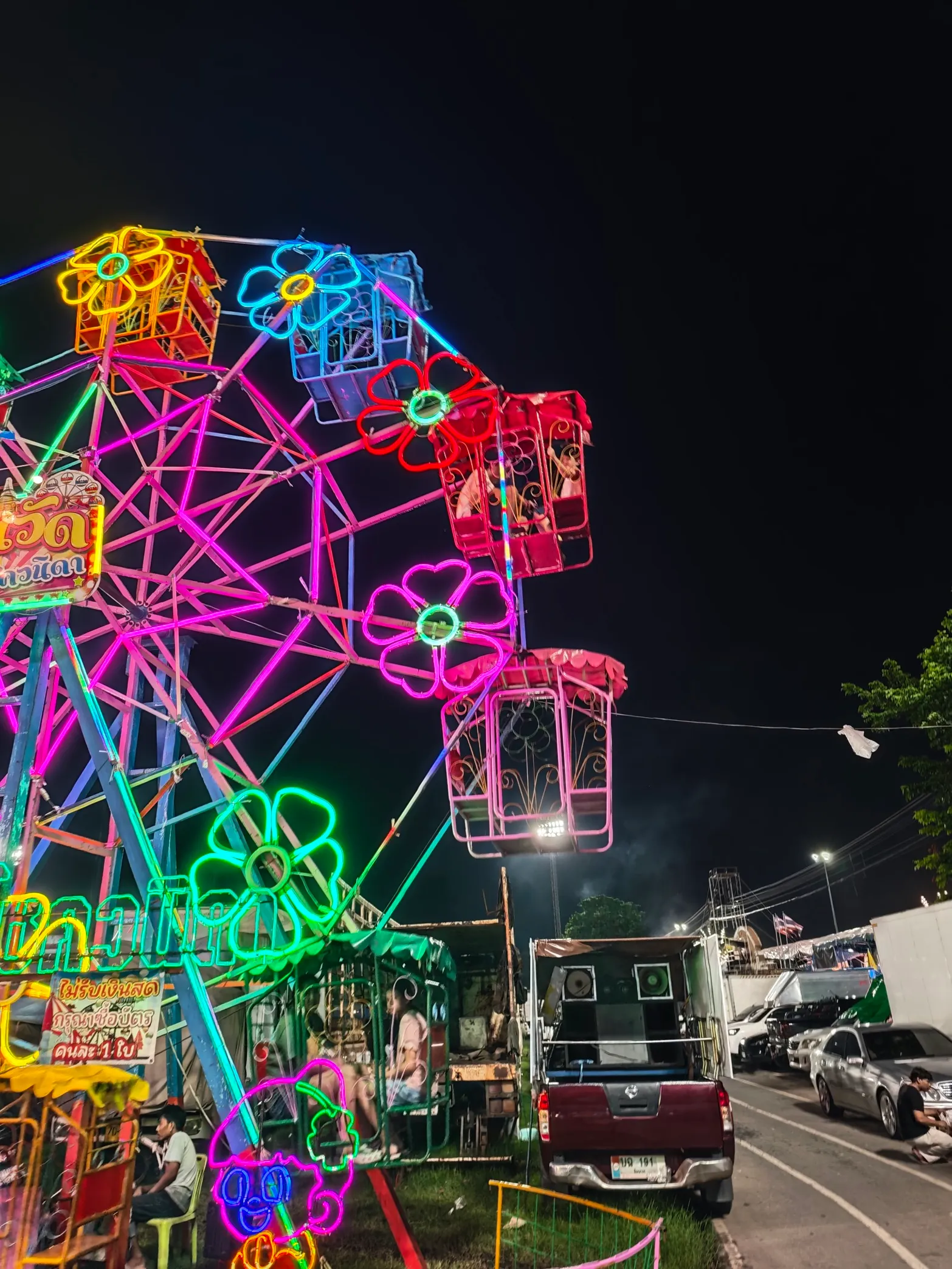 khun and neice bpanbpan take a ride at the night festival in chainat