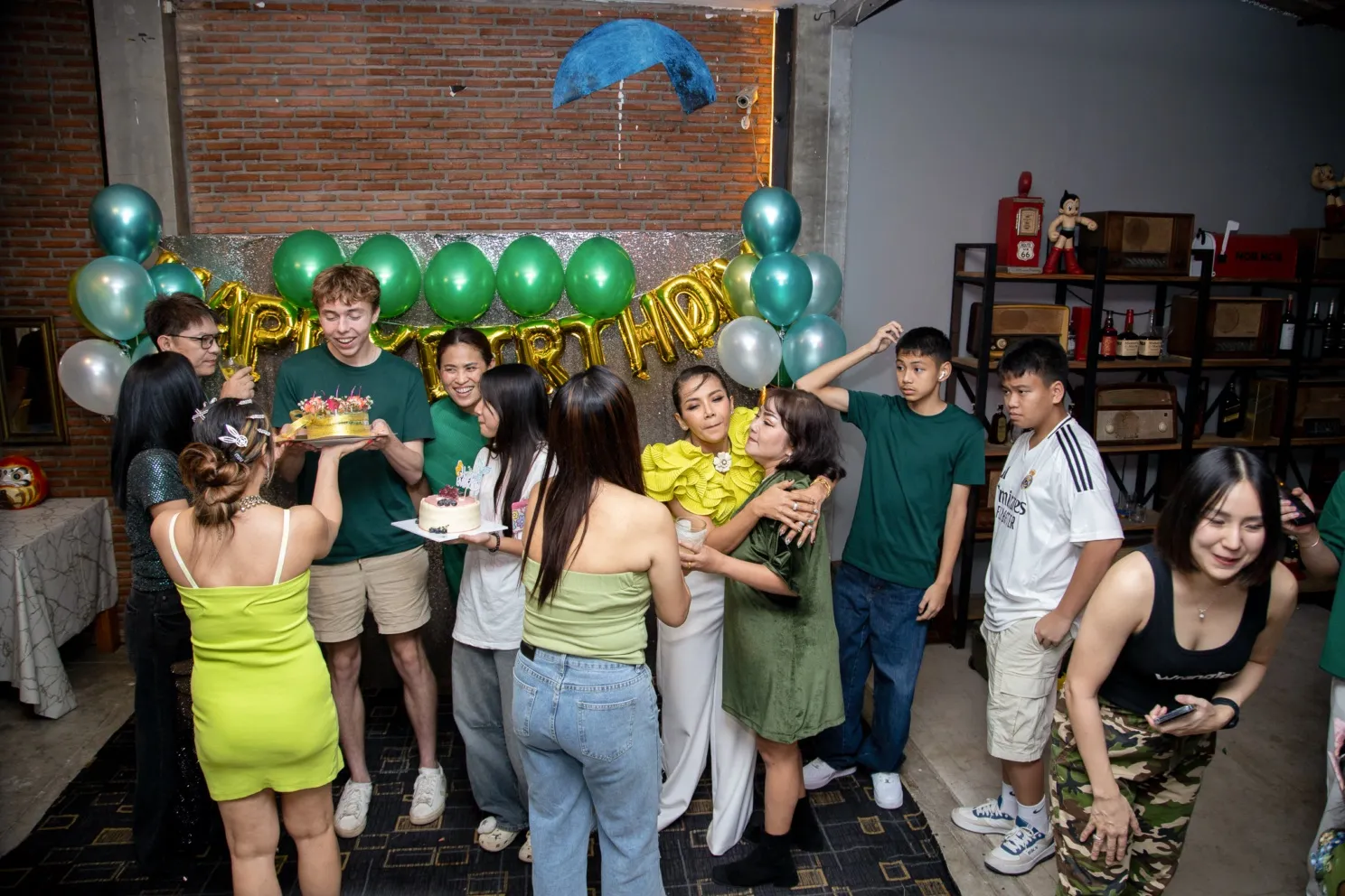 getting the (delicious) cake ready for mae phet. she is in the ruffly lime green top, seven from the left